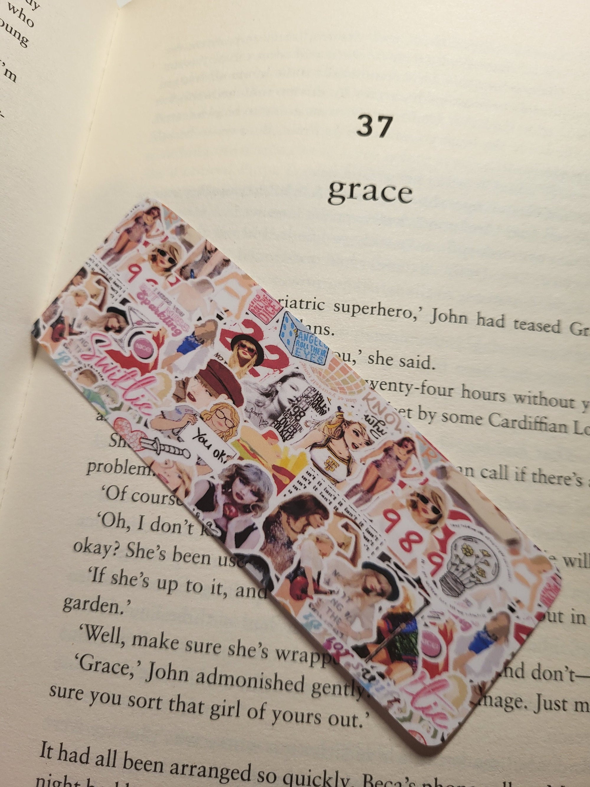 Book page with number 37, title "grace", and bookmark with stickers. Close-up shot.