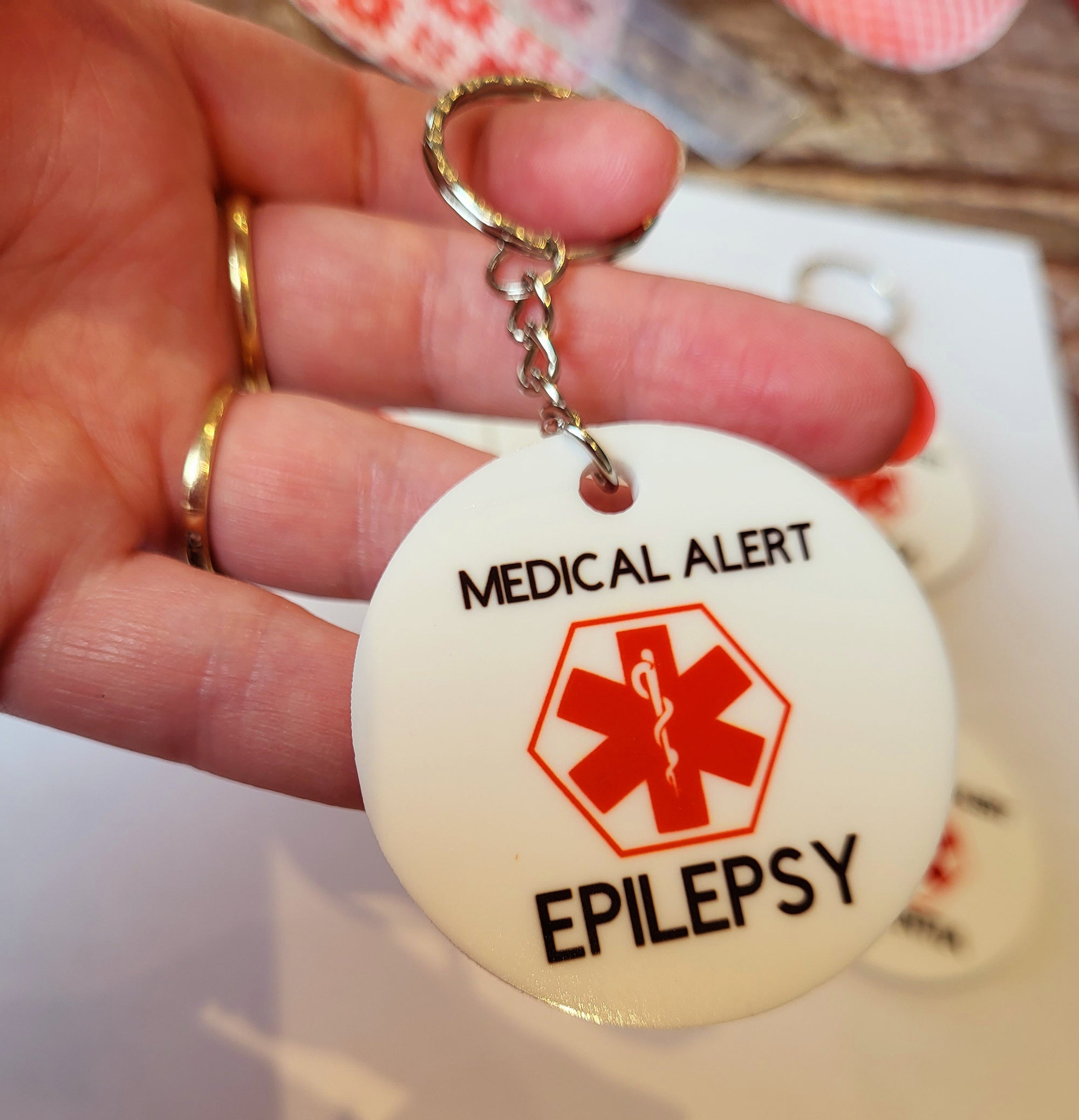 Medical Alert Keychain - Epilepsy. Red medical symbol on a white background. Essential safety accessory.